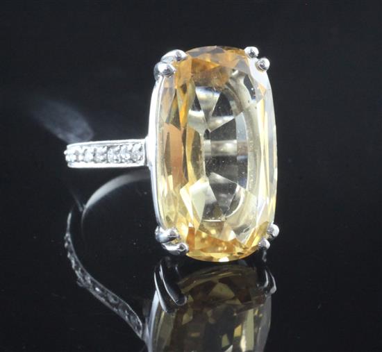 A white gold, yellow topaz and diamond set dress ring, size O.